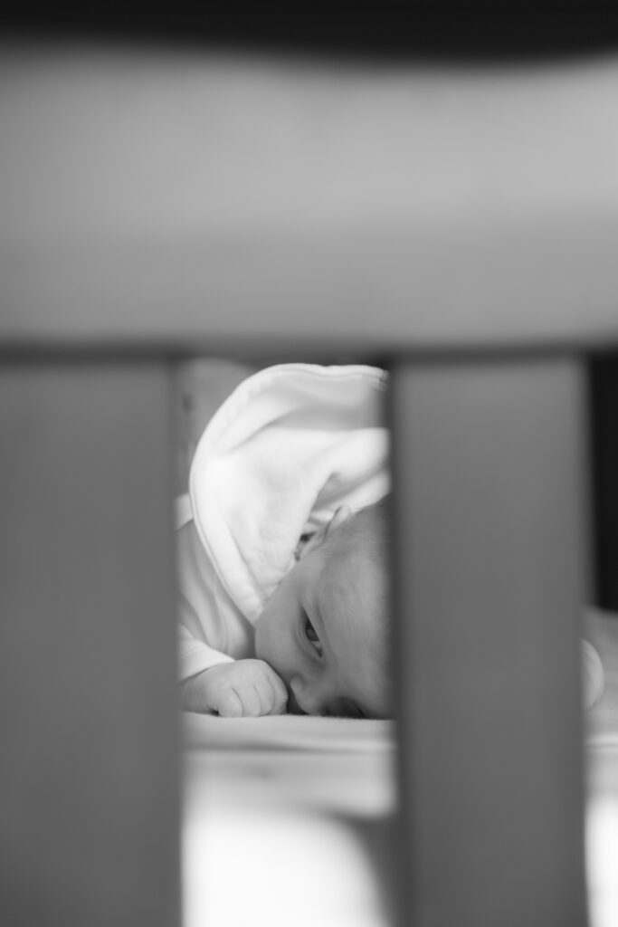 Baby stares through crib