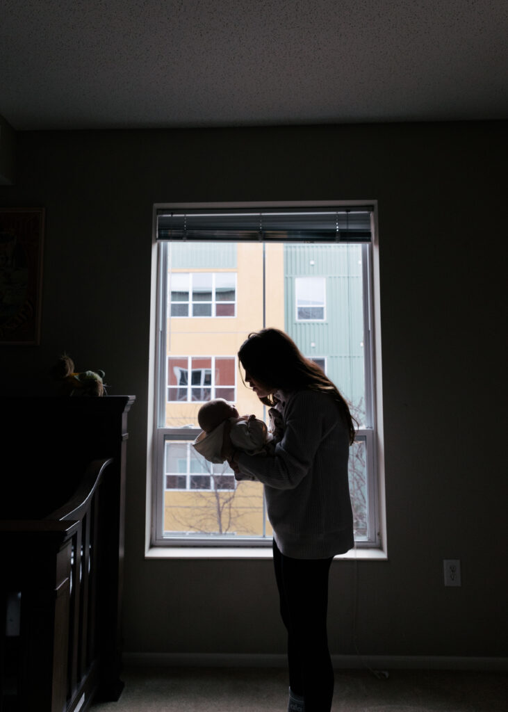 silhouette of a mom and her newborn 