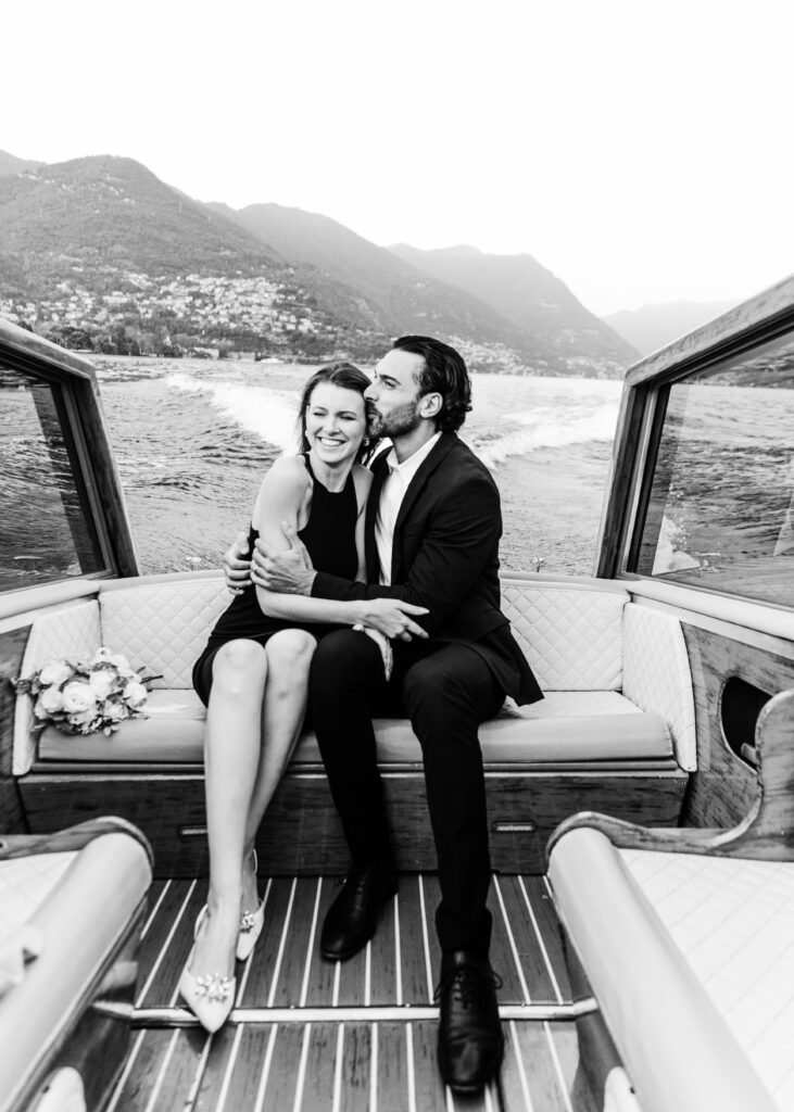 couple laughing on a boat in lake como, italy